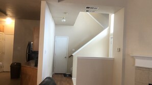 A living room with a sofa, a coffee table, and a fireplace. There is a staircase leading to another level. - Fetokai Suite Inn, this is a beautiful home and suites with your vacation (Arlington)