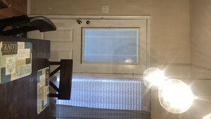 A hotel entrance with a reception desk, a door with a window, and a bright light fixture. - Fetokai Suite Inn, this is a beautiful home and suites with your vacation (Arlington)
