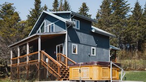 A two-story house with a large deck, a hot tub, and a staircase leading to the deck. - Incredible View, Privacy & Private hot tub! (Homer)