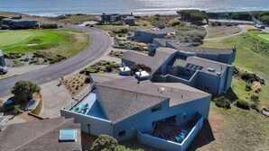 A coastal residential area with modern houses, a golf course, and a view of the ocean. - Ocean view easy access to Doran Beach, Golf  course and  Bluewater Bistro. (Bodega Bay)