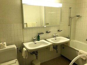 A bathroom with two sinks, a toilet, a shower, and a mirror. - Minusio-Locarno Navengana Apt. 3 (Minusio)