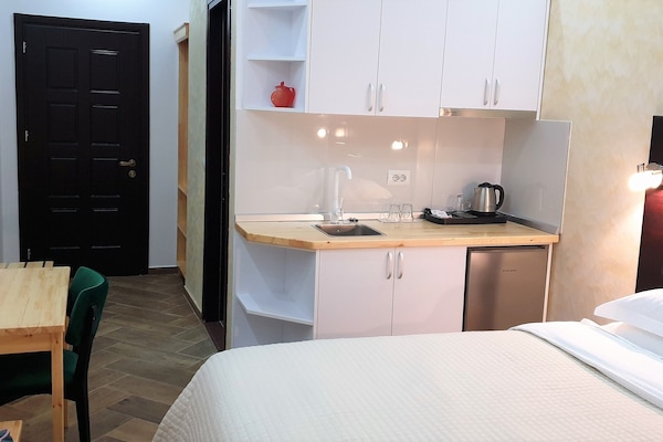 Deluxe Double Room | Private kitchen | Full-size fridge, dining tables