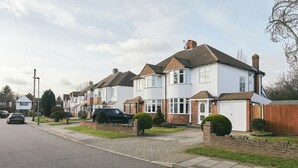 A row of two-story houses with a driveway and a parked car. - 16 Austin Avenue (Bromley)