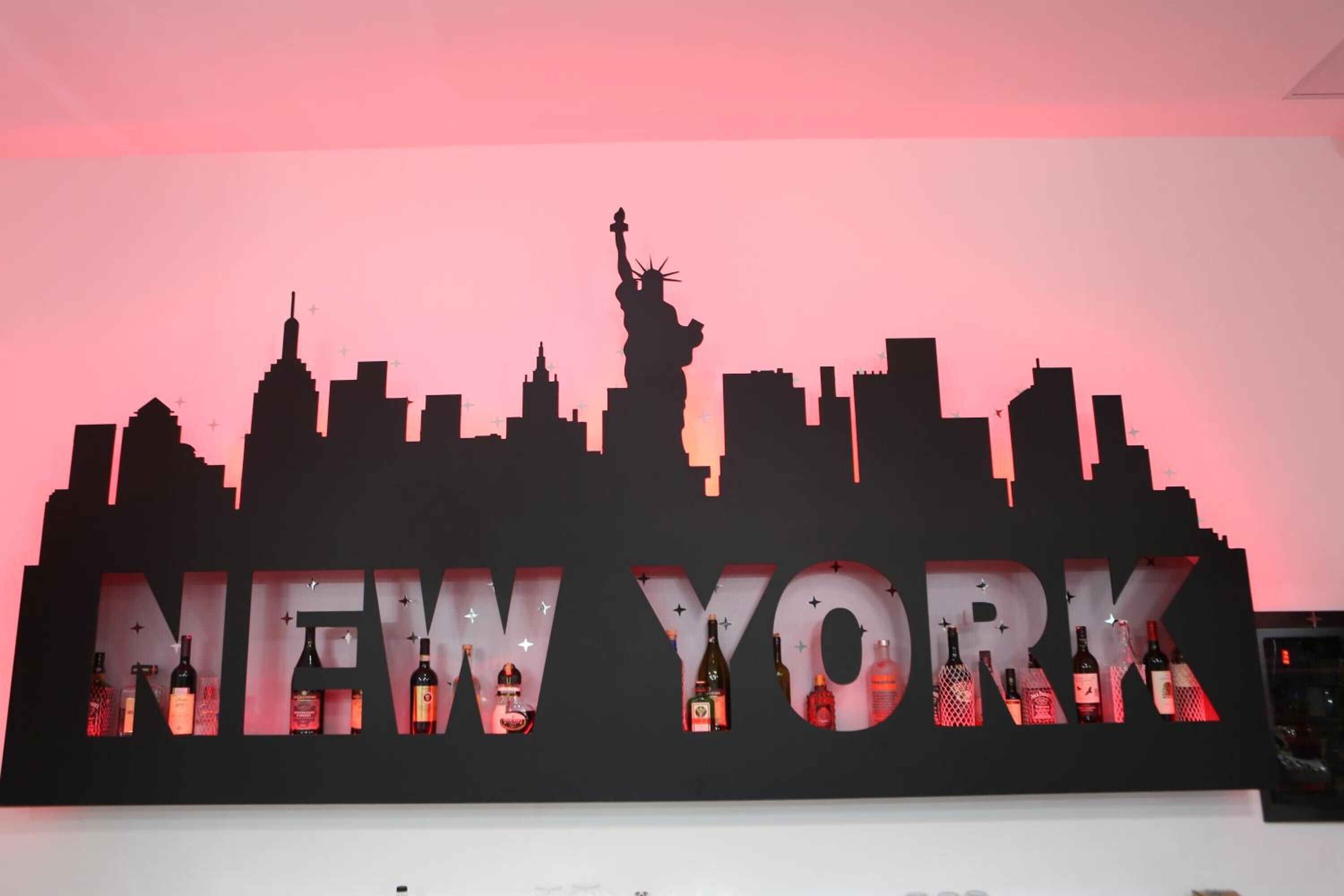 A wall with a silhouette of New York City skyline and the words 'NEW YORK' in large letters.