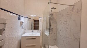 Shower, hair dryer, towels, toilet paper