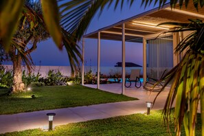 A modern outdoor patio area with a pool, seating, and a covered structure. - At the home of Giò, villa with pool (Marina di Ragusa)
