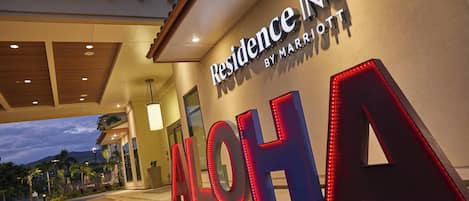 The entrance of a hotel with illuminated signage reading "Residence Inn by Marriott" and "ALOHA".