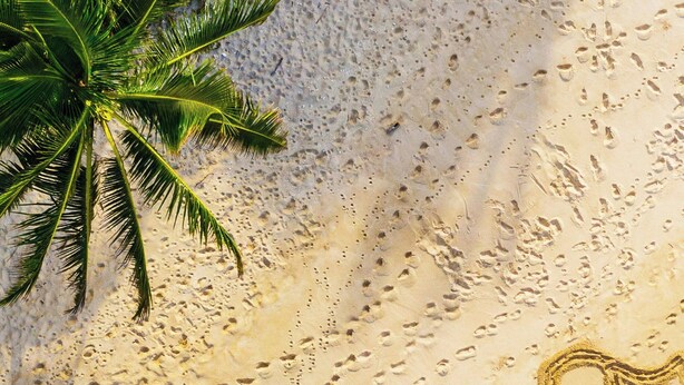 A beach with footprints spelling "Alhambra" and a palm tree. - Residence Inn by Marriott Oahu Kapolei (Kapolei)