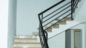 A staircase with clear glass steps and black metal railings. - Beautiful Secure Home With 24 hour Security (Accra)