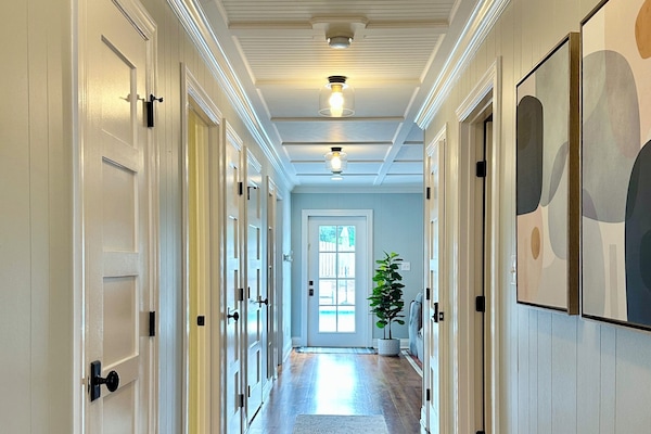 The hallway downstairs leads to the back door entry to the private pool patio