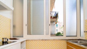 A kitchen with a window, a sink, and a stove. - Ritamar by Interhome (Sorrento)