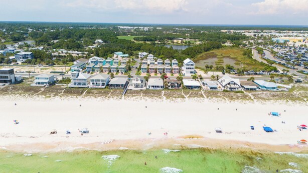 An aerial view of a coastal residential area with beachfront properties, a marina, and a parking lot. - Pier Park only 50 Steps to the beach! Pet friendly. Ocean View.  (Panama City Beach)