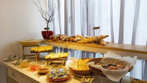 Disposição de buffet com diversos alimentos e um letreiro indicando uma área específica.