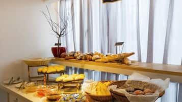 A buffet setup with various food items and a sign above indicating a specific section.