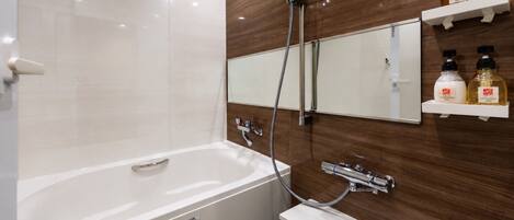 A modern bathroom with a bathtub, a shower, a sink, and a mirror. There are two shelves with toiletries.