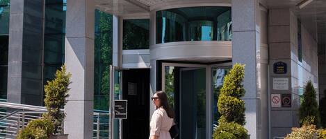 A modern hotel entrance with a clear sign reading 'HOTEL' above the doors.