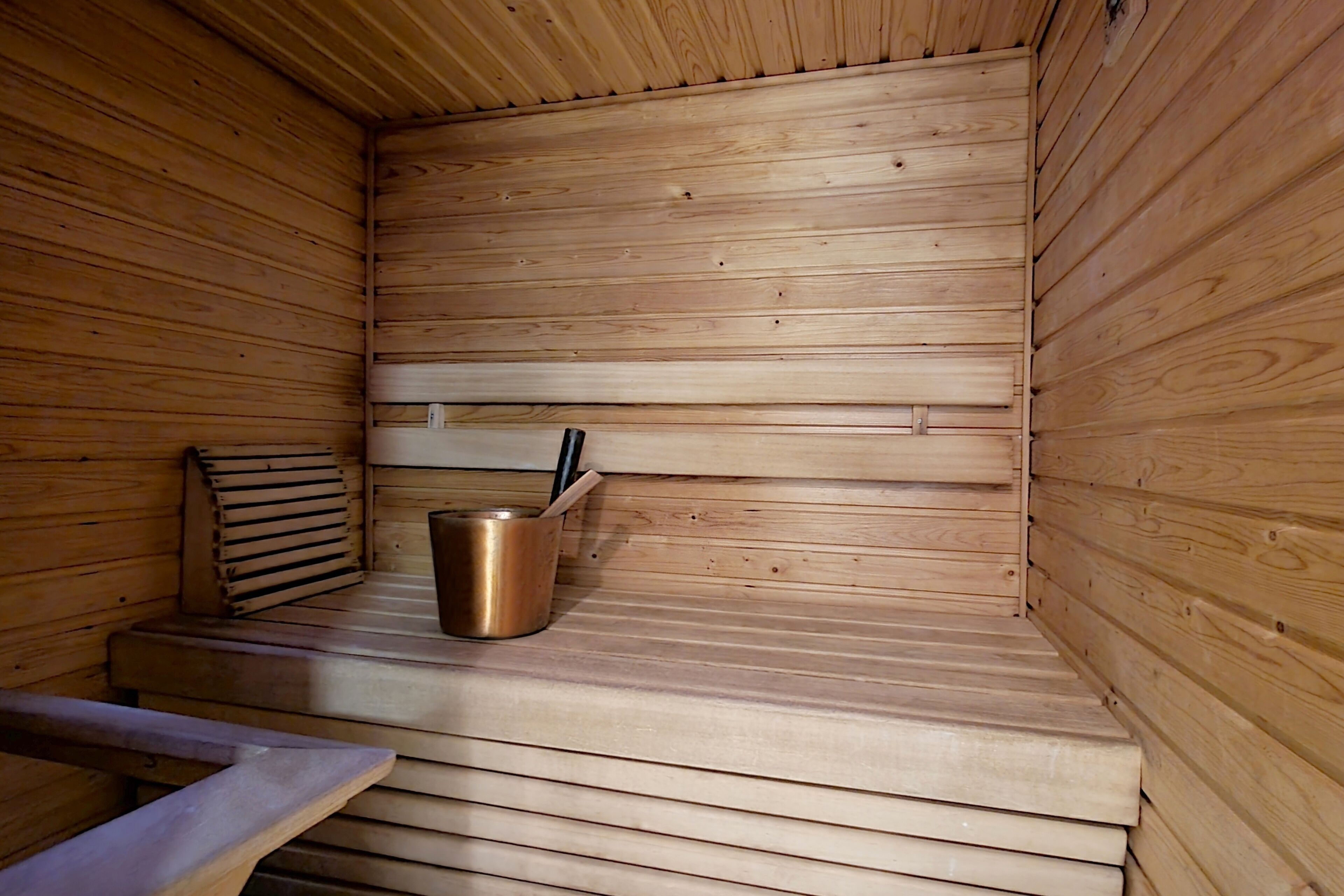 A sauna with wooden walls and benches.