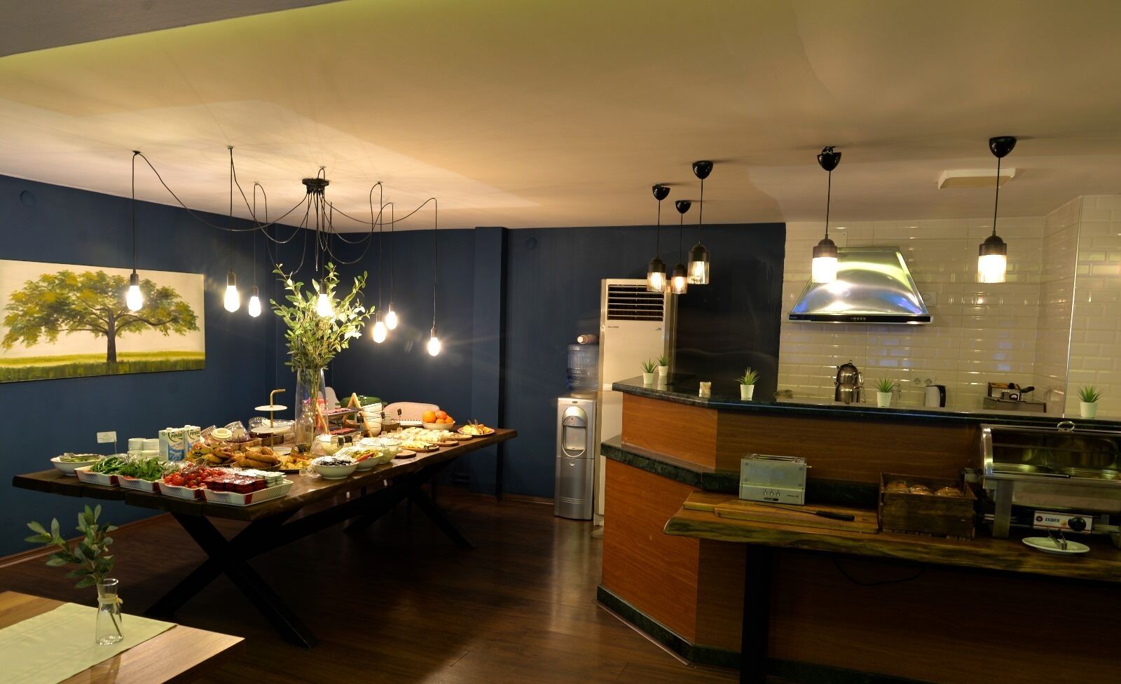 A modern kitchen with a buffet table, a refrigerator, and a coffee machine.