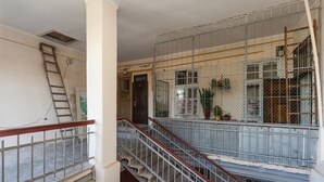 A multi-level building with a staircase and a metal fence.