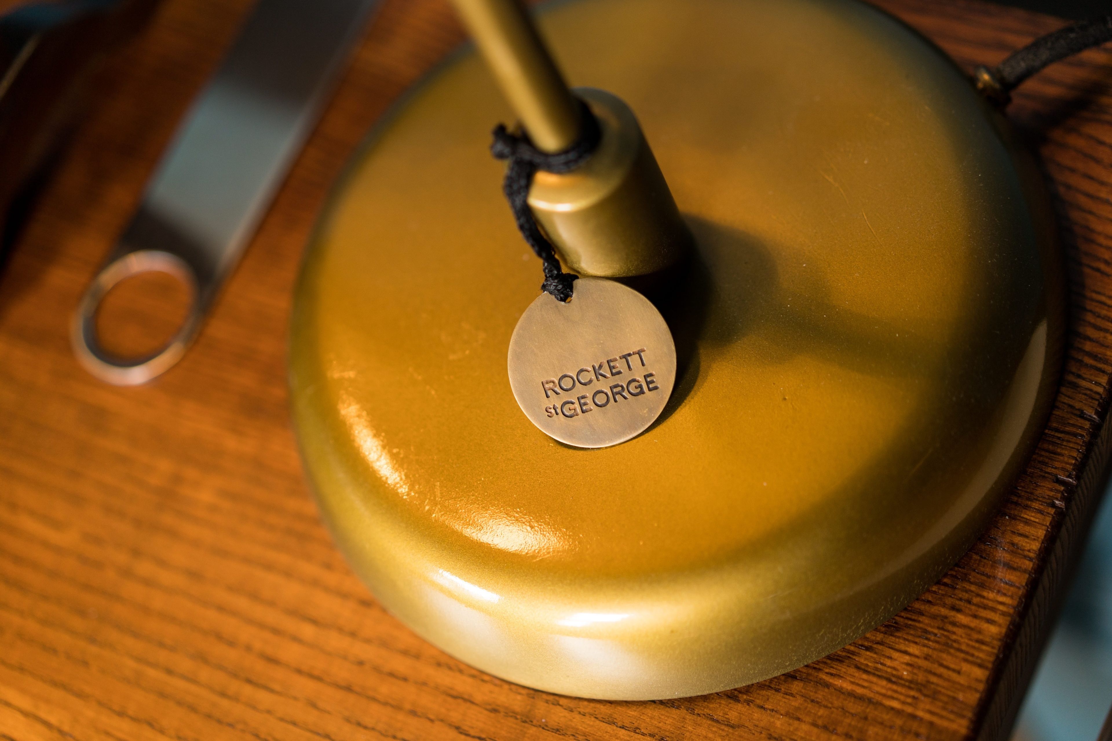 A vintage radio with a circular, metallic top and a tag that reads "ROCKET S GEORGE".