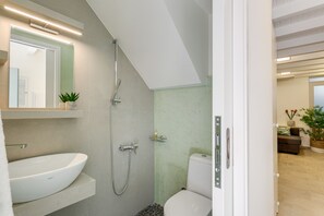 A modern bathroom with a white sink, a shower, and a toilet. - Chania Escapes Old Town-Casa Barchetta- Adults Only (Chania)
