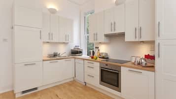 Two-Bedroom Apartment | Private kitchen | Full-size fridge, microwave, oven, stovetop