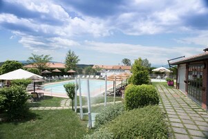 Seasonal outdoor pool, open 10:00 AM to 7:00 PM, pool umbrellas