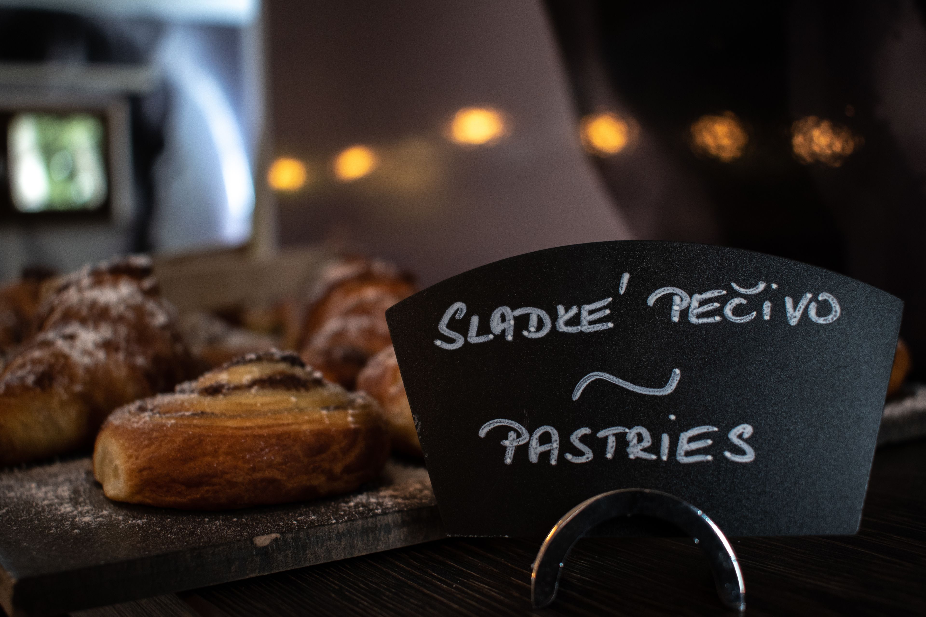A chalkboard sign with pastries and the text "Sláde' Pectivo Pastries".