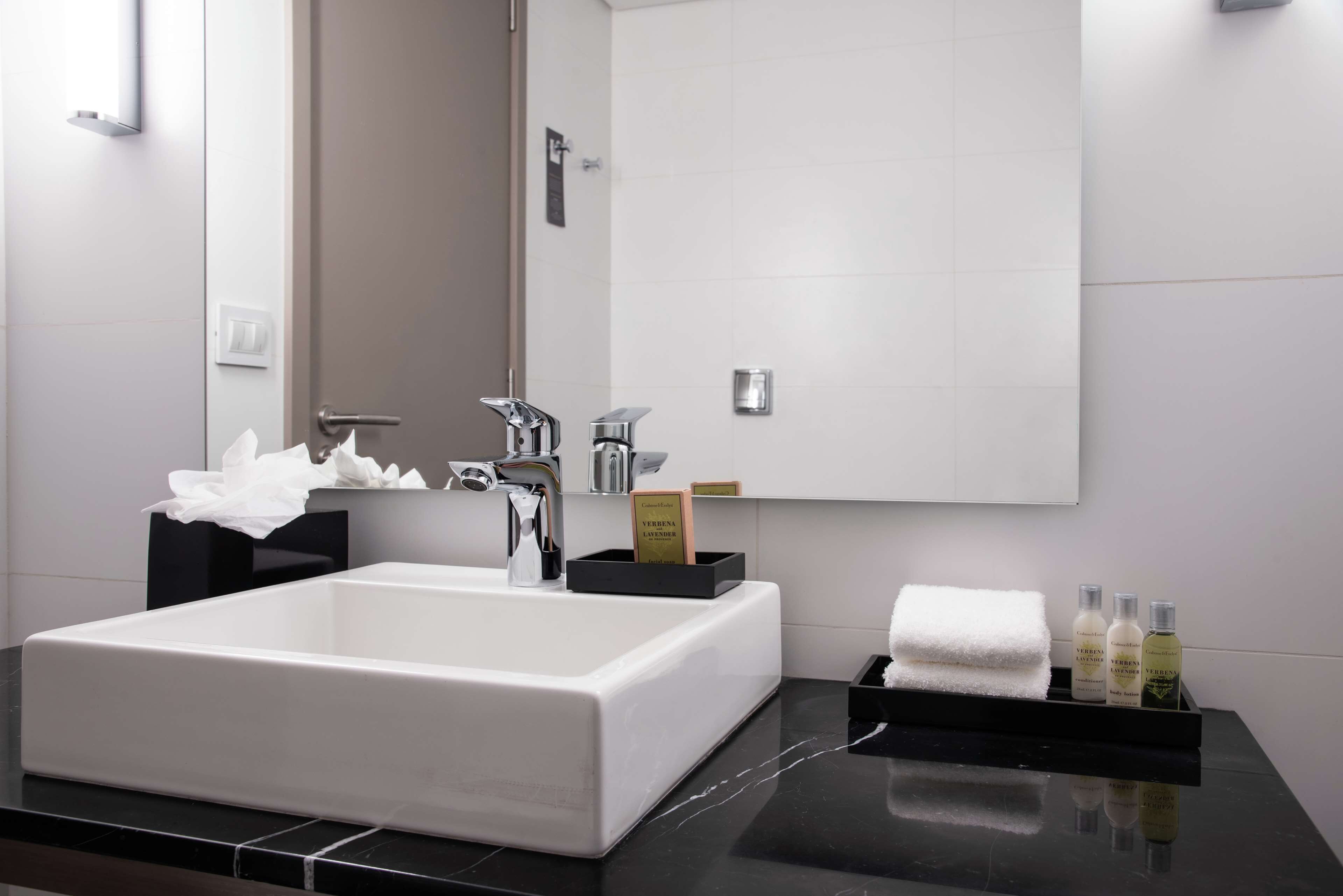 combined shower/bathtub, designer toiletries, hair dryer, bathrobes
