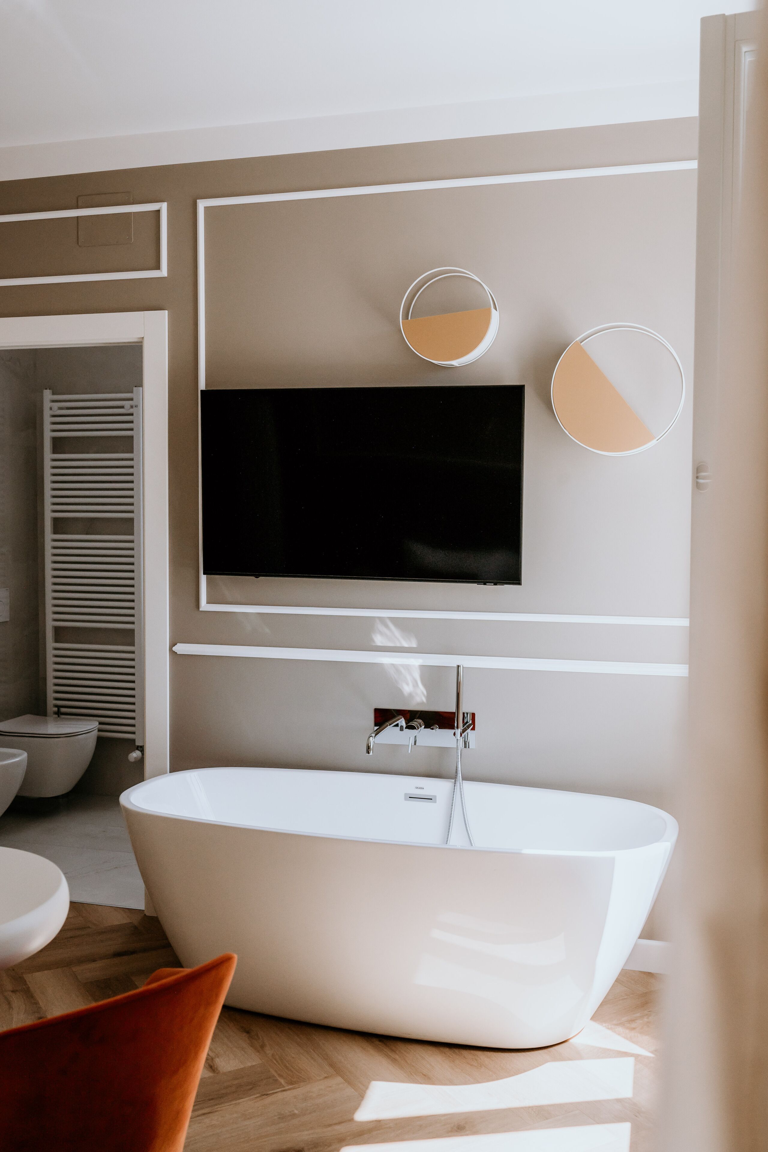 A modern bathroom with a freestanding bathtub, a toilet, and a sink.