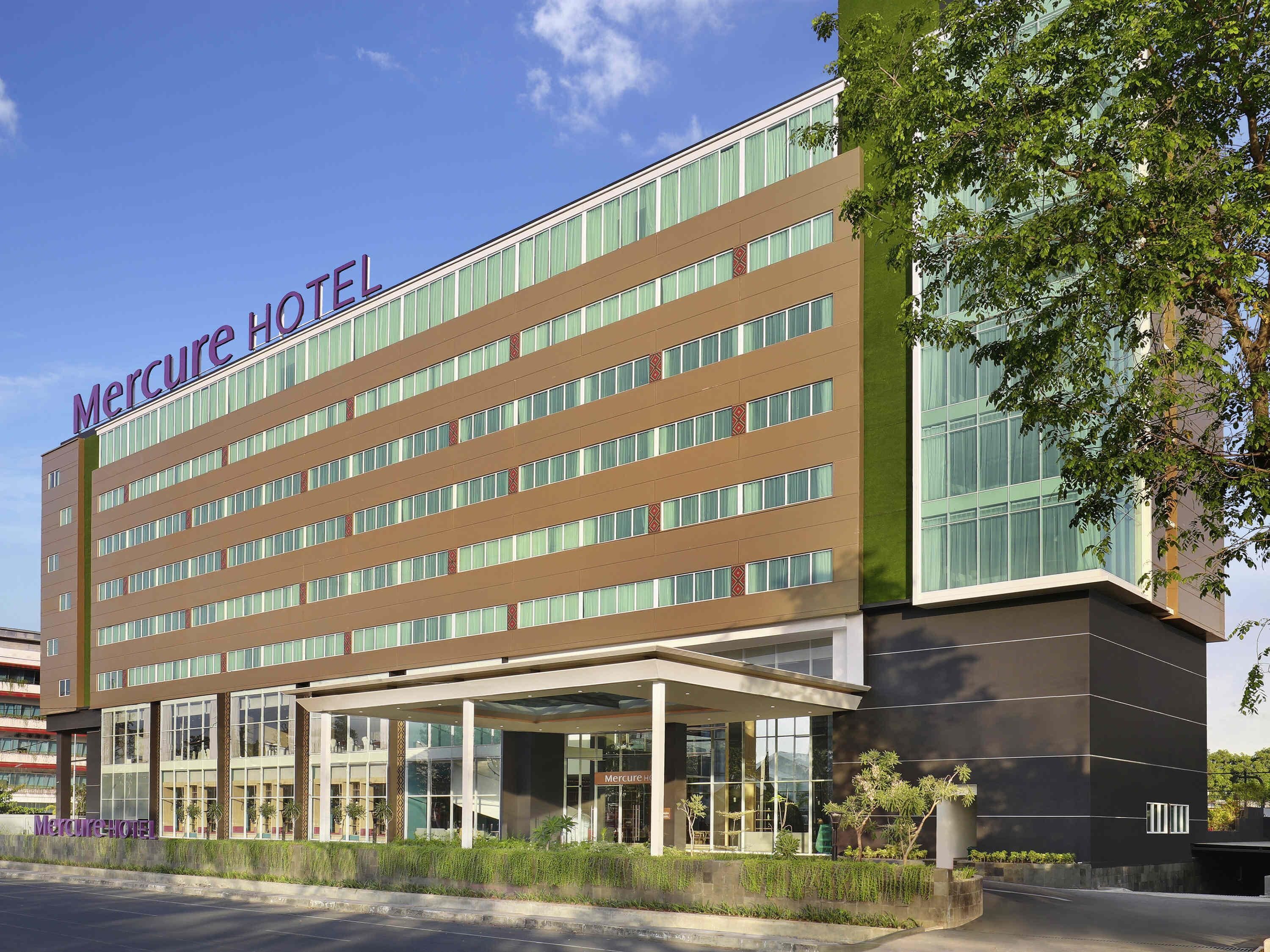 A modern hotel building with a sign reading "Mercure Hotel".