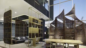 A modern interior with a dining area, a sofa, and decorative screens.