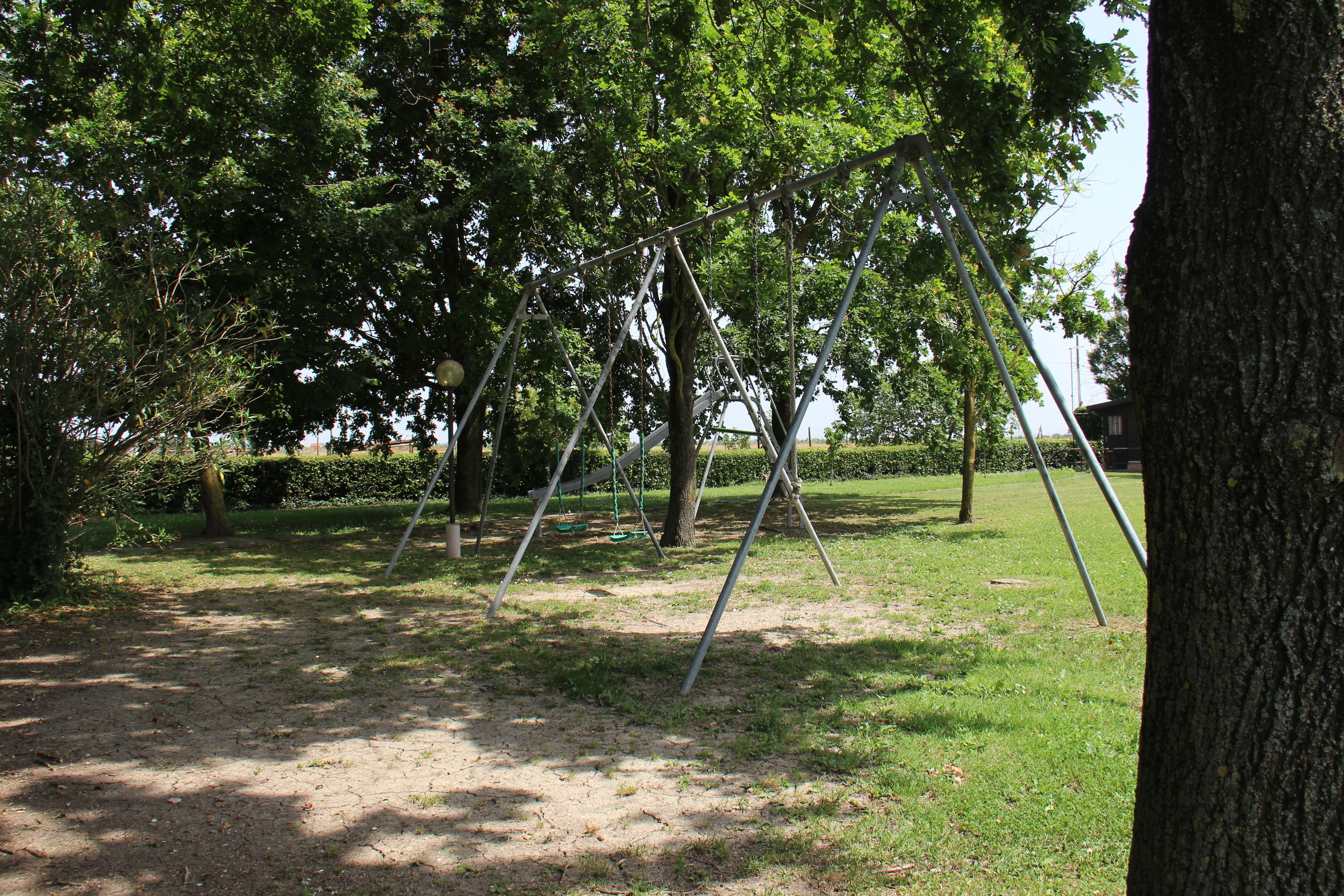 Un parque con columpios y árboles.