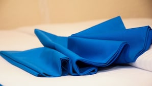 A bed with blue linens. - Zebra Tourism  Hotel (Kigali)