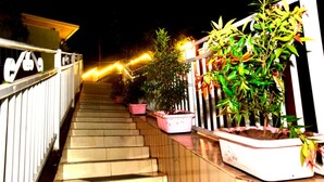 A staircase leading to a balcony with potted plants and a railing. - Zebra Tourism  Hotel (Kigali)