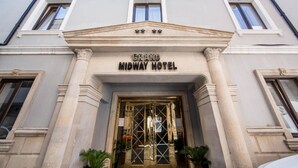 The Grand Midway Hotel entrance with a classical facade, columns, and a symmetrical window arrangement. - Grand Midway Hotel (Baku)