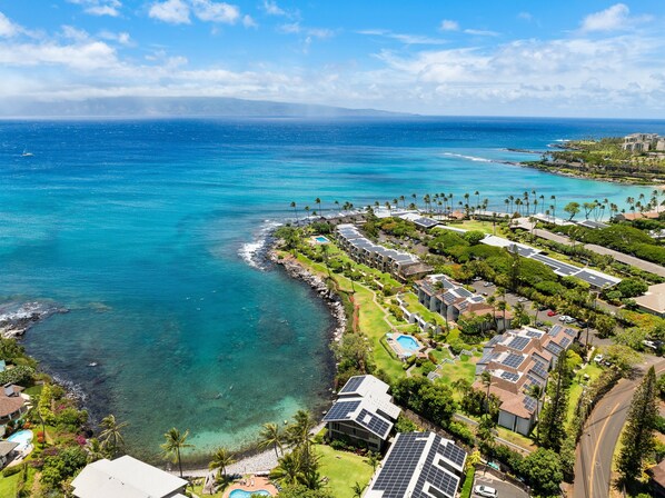 A coastal resort with ocean views, solar panels, and a swimming pool.