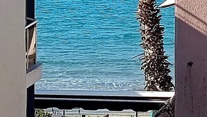 A view of a building with a balcony overlooking a body of water. - Erciyes Otel Kusadasi (Kusadasi)