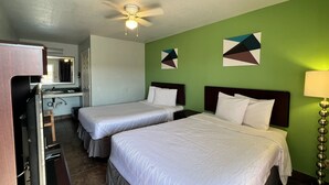 A hotel room with two beds, a ceiling fan, a sink, and a mirror. - Hwy 59 Motel Laredo Medical Center (Laredo)