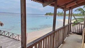 A wooden deck with a view of a beach and ocean. -  San Blas Paradise Private Cabins on Shipwreck Island - meals included (Ailigandi)