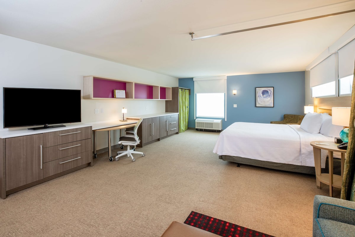 Hypo-allergenic bedding, desk, laptop workspace, blackout drapes