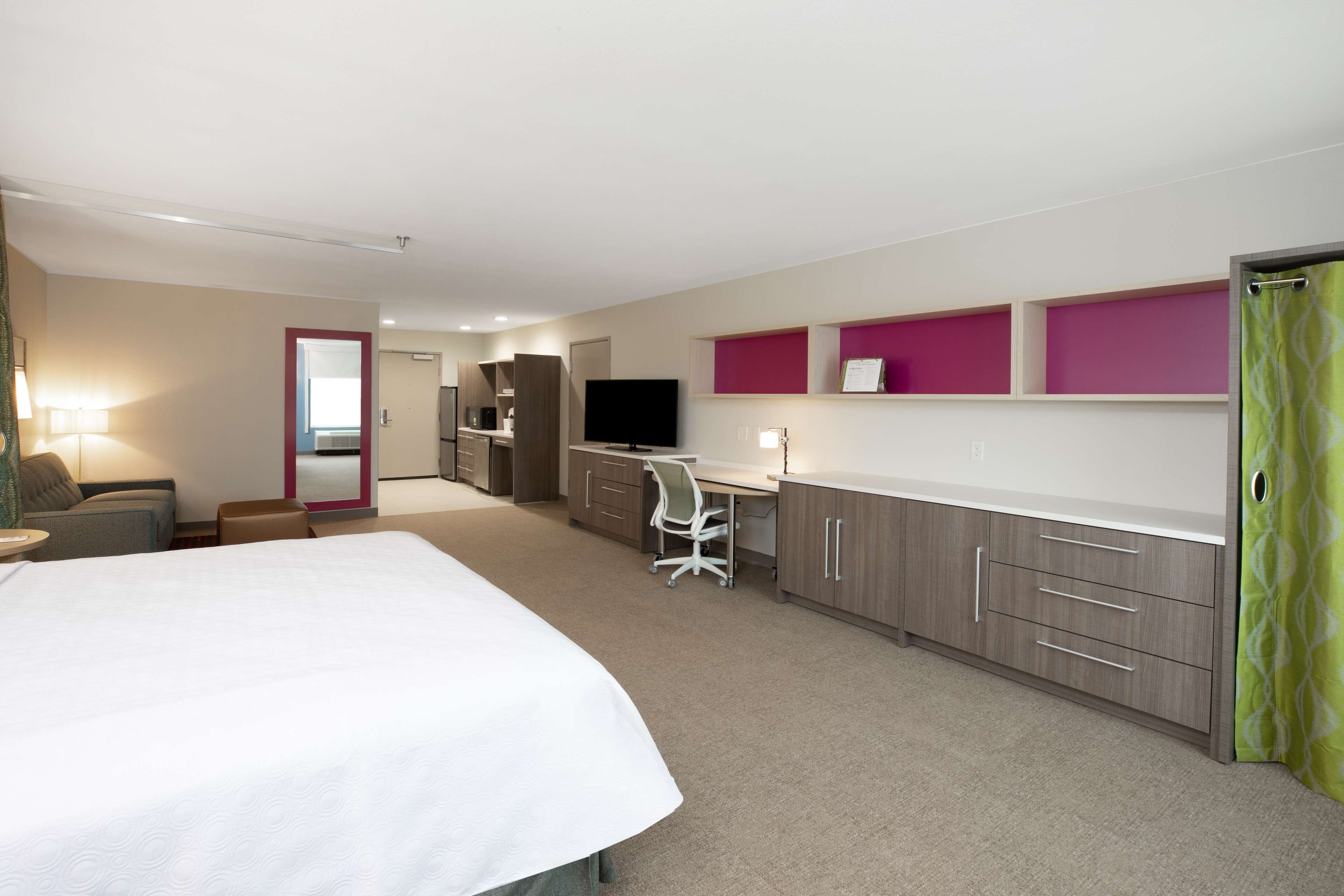 hypo-allergenic bedding, desk, laptop workspace, blackout curtains