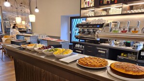 A buffet bar with various food items and a coffee machine. - Il Sole Bergamo (Bergamo)