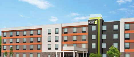 A multi-story hotel with a modern design, featuring a prominent "HOME2" sign.
