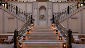 A grand staircase with a central archway, flanked by two staircases on either side, leading to the upper floors of a building. - The Harpeth Franklin Downtown, Curio Collection by Hilton (Franklin)