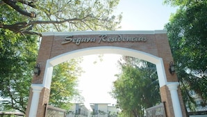 An entrance archway with the text "Segava Residencias" above it, leading to a parking area with a car parked inside. - Segara Residencias (Olongapo)