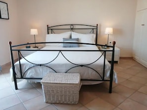 Cozy retreat with a single bed, bedside tables, and a wicker basket.
