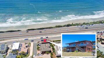 Stunning coastal views from this two-story house with a front yard and staircase.