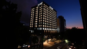 A high-rise hotel with multiple floors, illuminated windows, and a prominent signage at the top. - Orakai Daehakro Hotel, BW Signature Collection (Seoul)