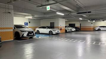 A multi-level parking garage with several white cars parked.